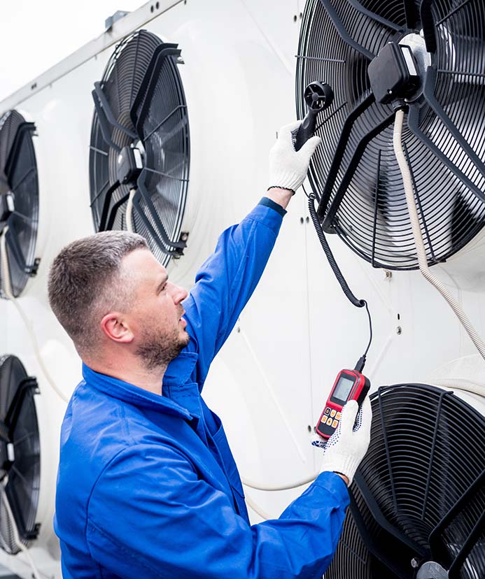 Technician checking a commercial condensing unit